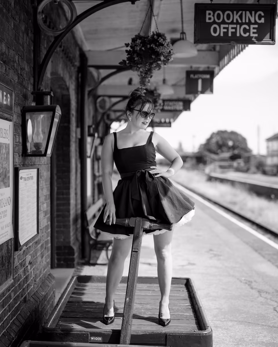 Vintage style woman in black dress on a station platform by Dave Lynes Photography.